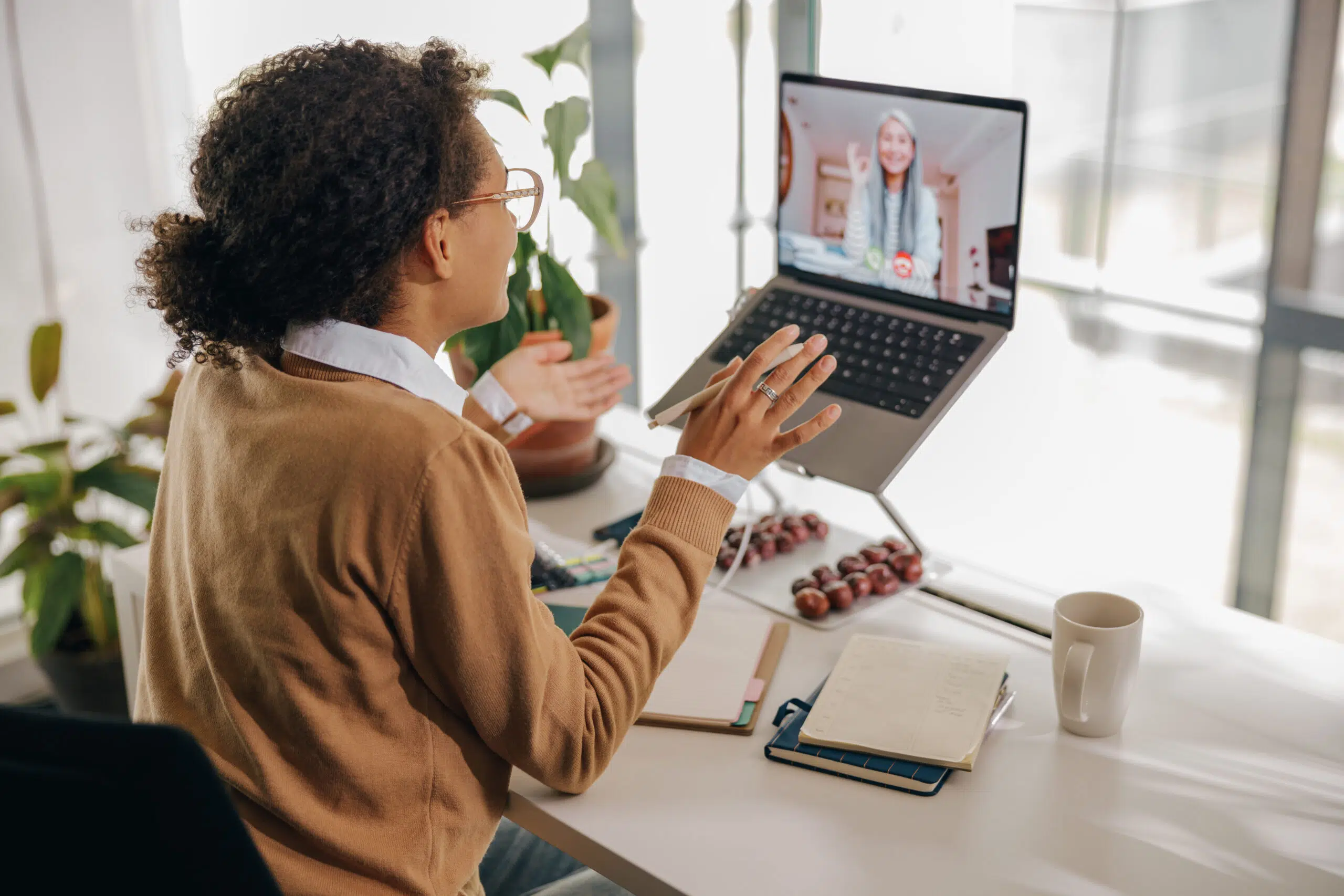 Female freelancer have video conference with client while sitting in cozy coworking