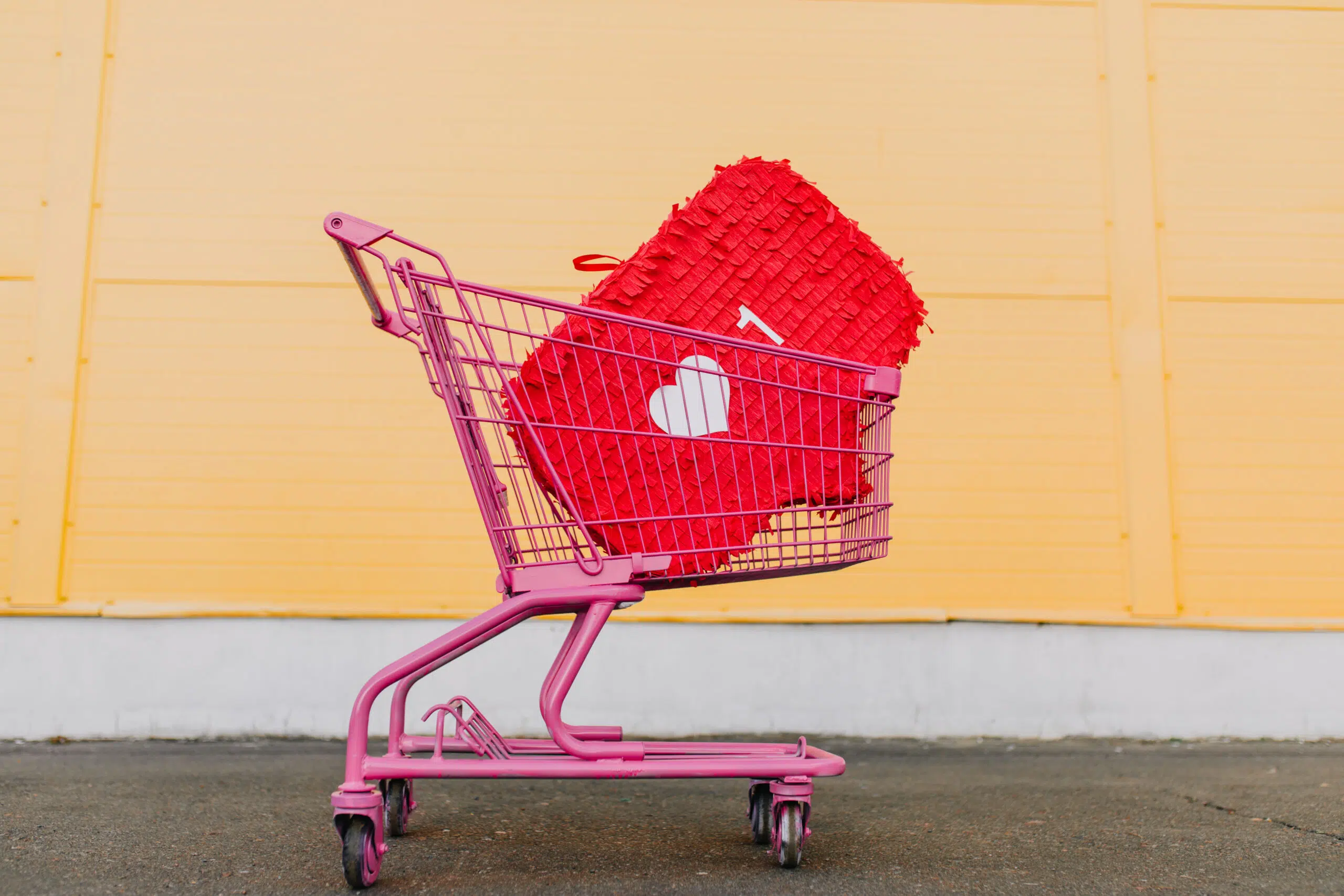 Photo of pink shopping cart with heart icon, happy valentine's concept