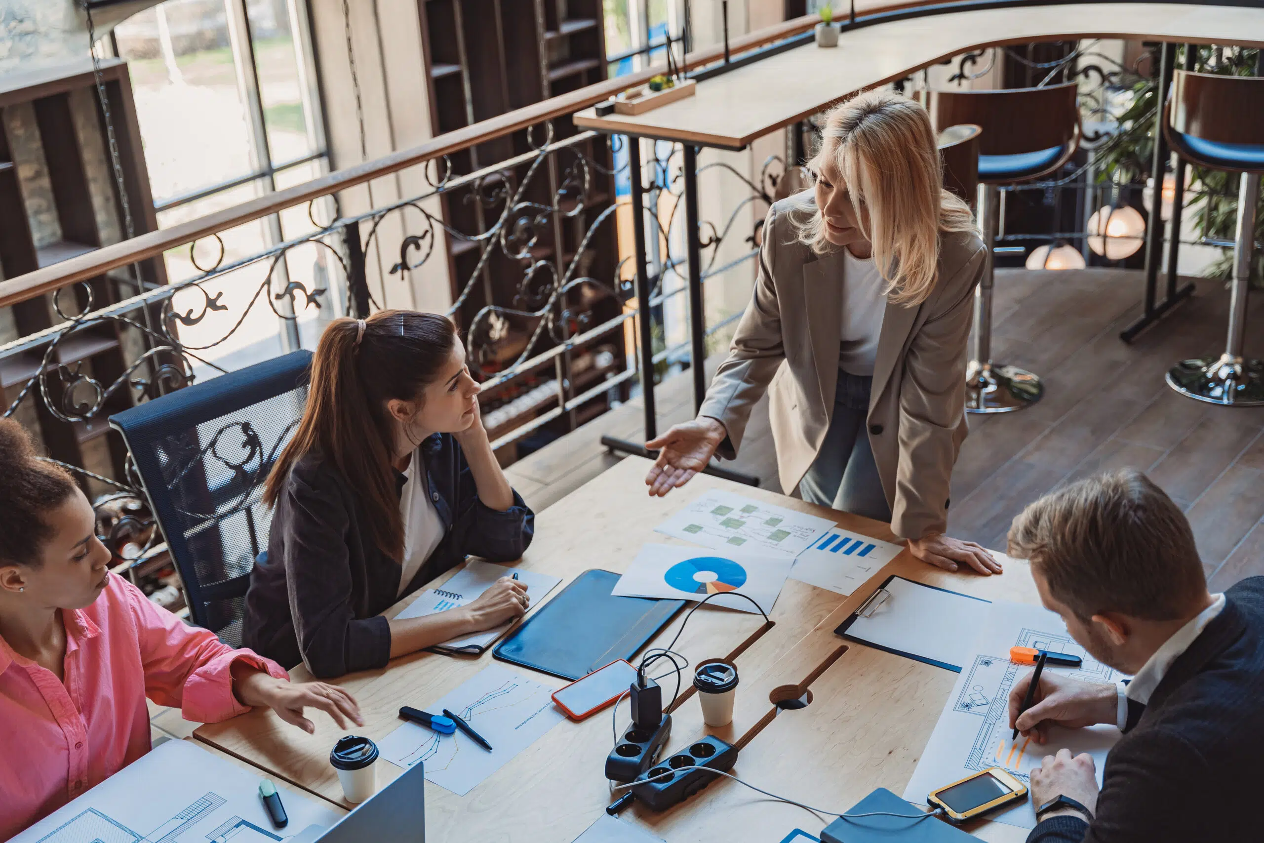 Group of colleagues working together on project in modern coworking